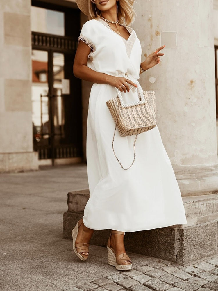Stijlvolle witte dames hoge taille zomer midi jurk. Elegante hollow out details en een comfortabele losse pasvorm.
