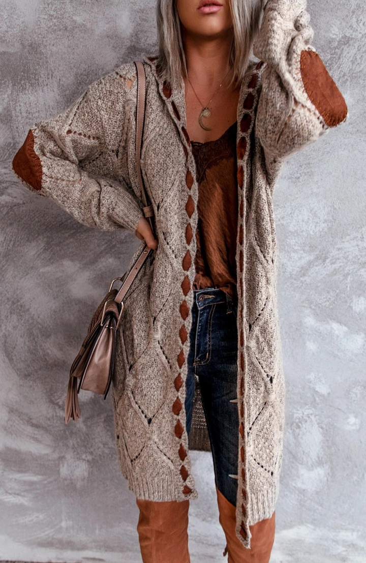 Trendy lang vest voor dames, met capuchon en elegante snit voor een moderne look.