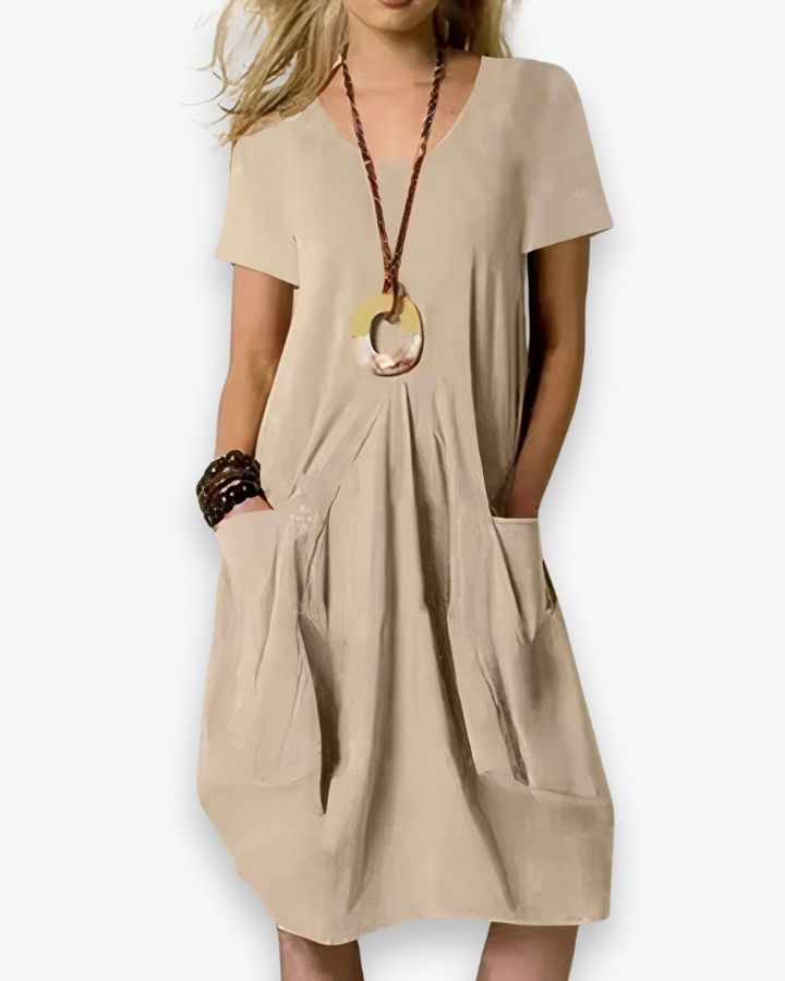 Veelzijdige dames midi-jurk, comfortabel en modieus, met elegante plooien en een luchtige pasvorm.