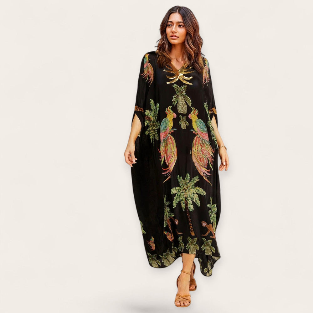 Wijde dames kaftan met losse pasvorm en levendige tropische print. Perfecte enkellange zomerjurk.