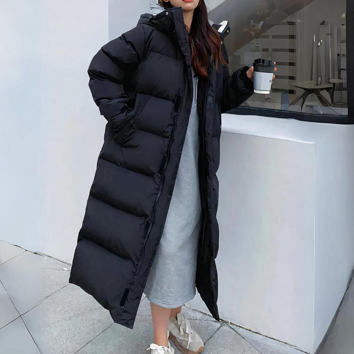 Lange water- & winddichte zwarte dames winterparka met capuchon, ideaal voor optimale warmte en bescherming.