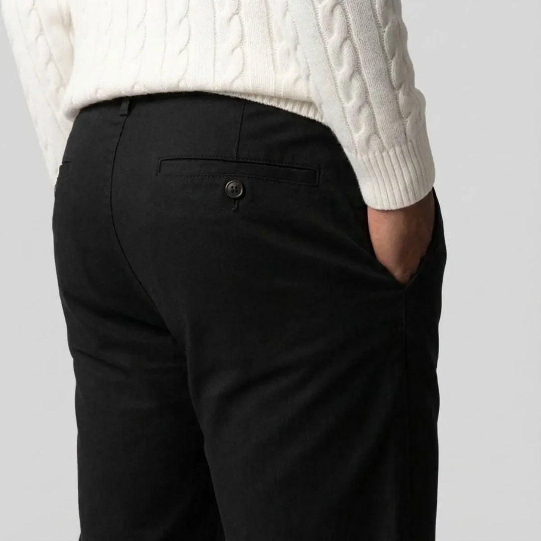 Close-up van de stof van een zwarte heren chino. Comfortabele broek met regular fit en rechte pijpen.