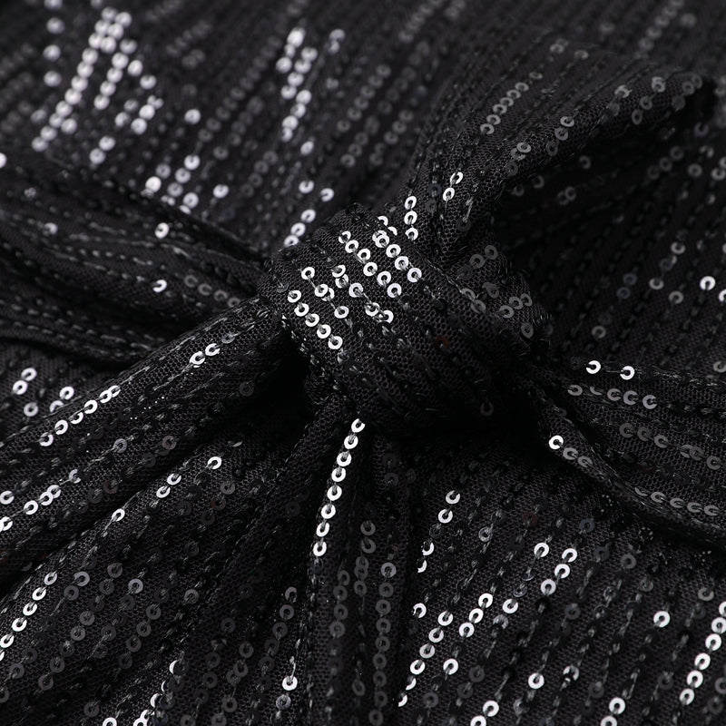 Sprankelende dames glitterjurk in zwart met ceintuur, de ideale chique avondjurk.