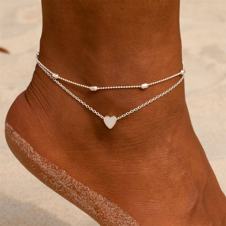 Sierlijk dames enkelbandje met dubbele ketting en charmante hartbedel. Prachtig sterling zilveren sieraad.