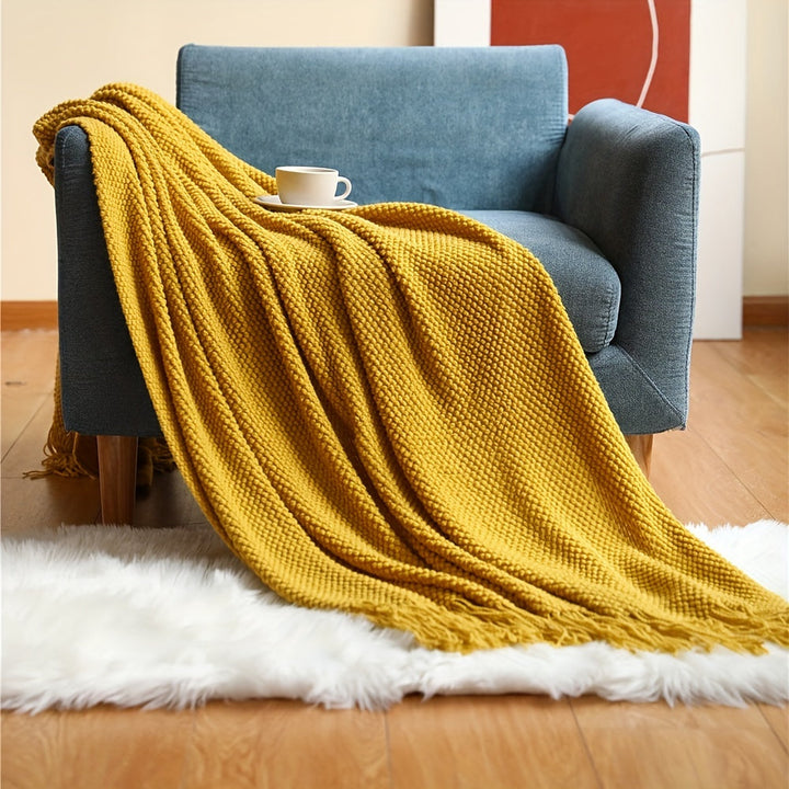 Acryl woondeken met zachte bubbeltextuur en sierlijke kwastjes, een must-have voor je bank.