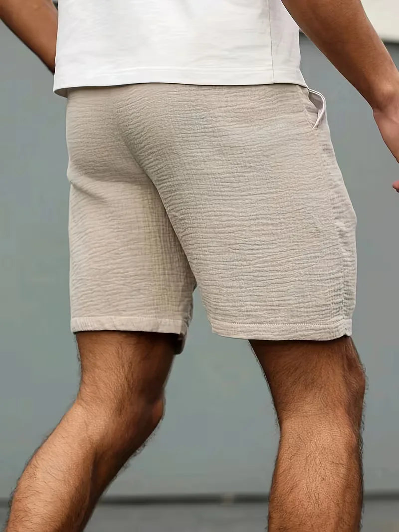 Veelzijdige beige heren korte broek met elastische taille, comfortabel voor strand, vakantie en casual.