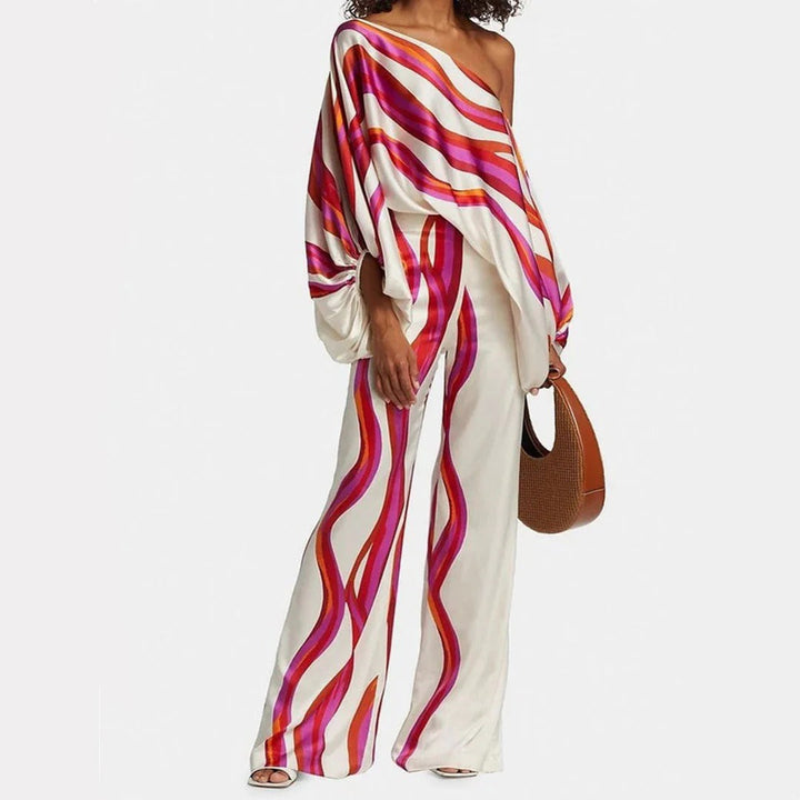 Modieuze fuchsia dames zomer set, tweedelig off-shoulder met wijde pijpen broek. Trendy en chic voor elke vrouw.
