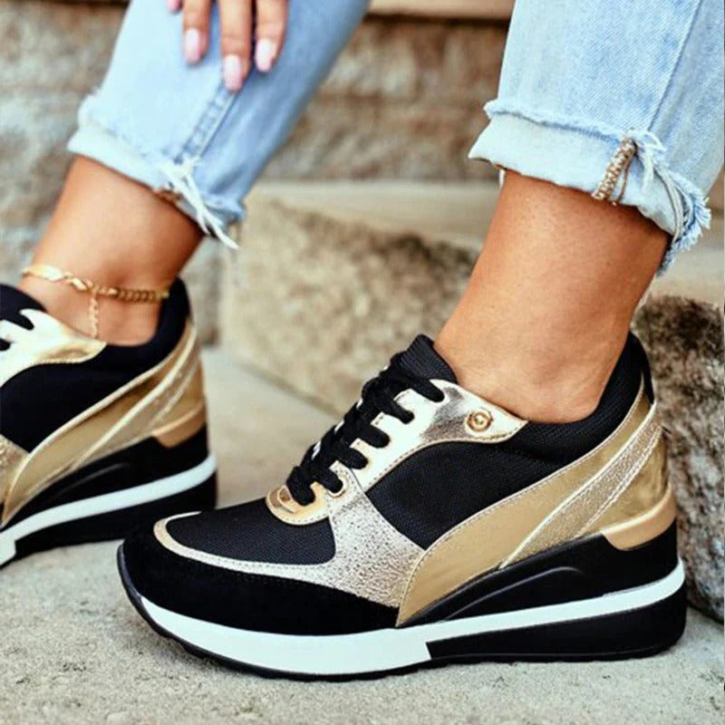 Casual zwarte damessneakers voor damesmode met gouden details, voorzien van corrigerende zool voor comfort.