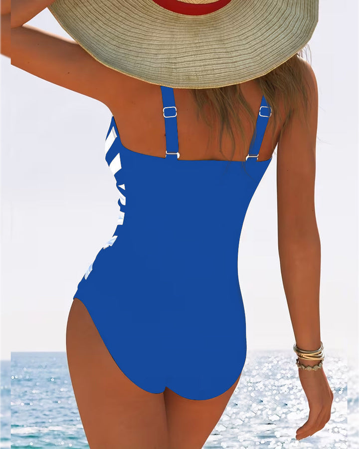 Model draagt elegant zwart damesbadpak met V-hals, flatterend voor strand en zwembad.