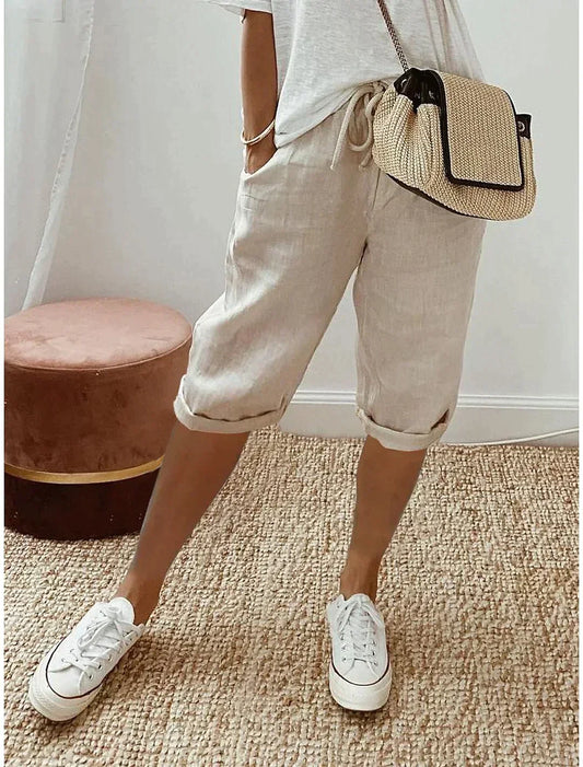 "Beige, blauwe en groene linnen zomerbroek voor dames, elegant en ademend, ideaal voor warme dagen."