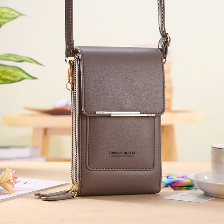 Multifunctionele compacte dames handtas, ideaal als reistas of feesttas, met speciaal telefooncompartiment.