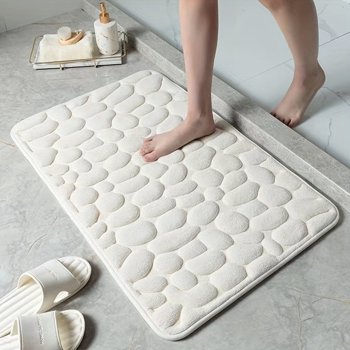 Zachte, absorberende polyester badmat; voorkomt uitglijden in de douche.