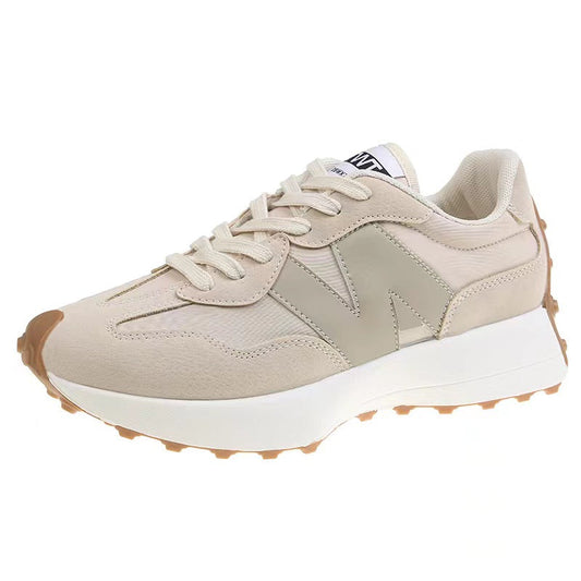 "Chique damessneakers aan zijaanzicht; stijlvolle beige trainers met moderne look en comfortabele pasvorm."