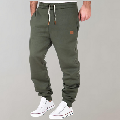 "Comfortabele heren joggingbroek met baggy pasvorm, grijs van kleur, verstelbare tailleband, ideaal voor sport en casual."