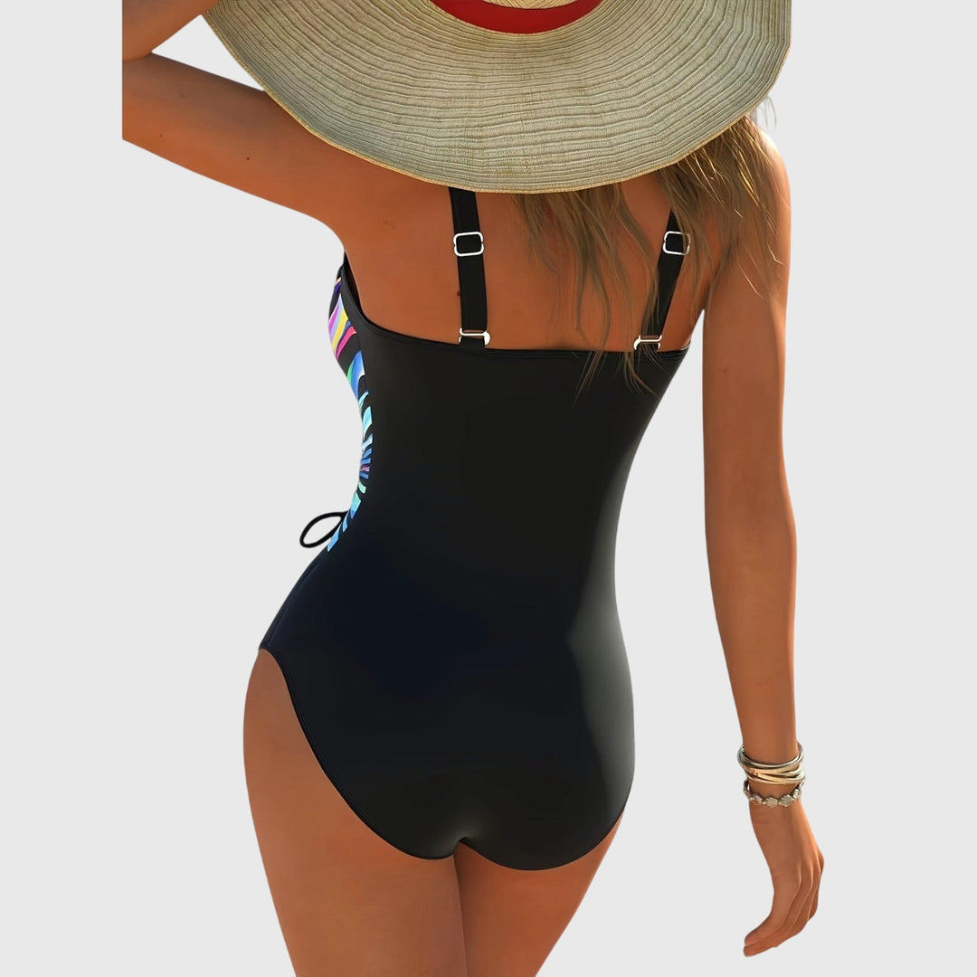 Stijlvol dames badpak met gekruist voorpand, V-hals en zijrimpeling. Comfortabele zwemkleding.