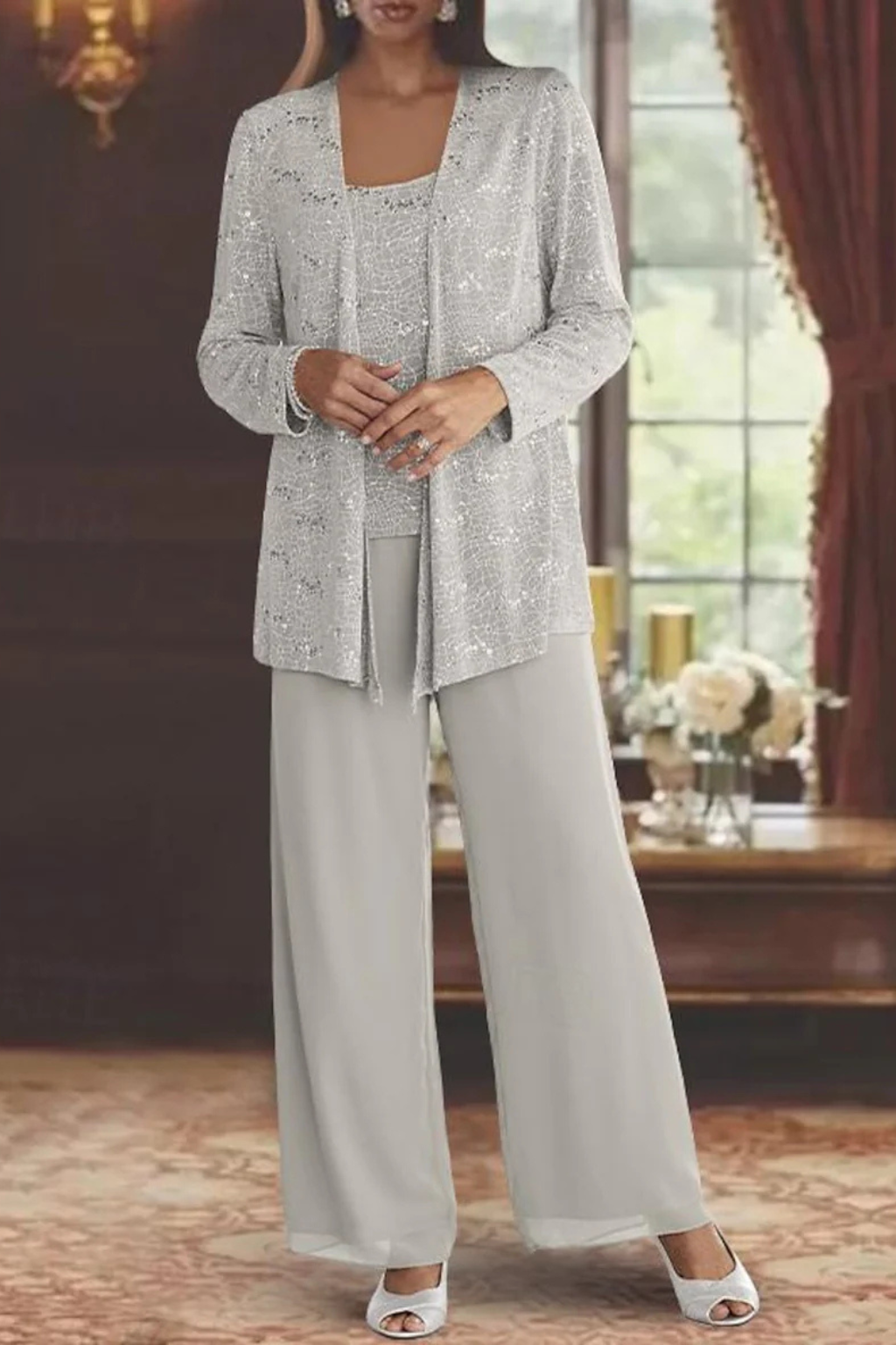 Elegant dames broekpak met glinsterend pailletten jacket en stijlvolle wijde broek.
