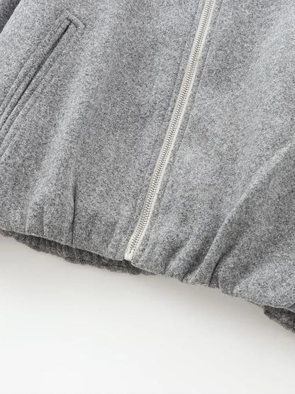 "Dames grijze bomberjas met ritssluiting, elastische tailleband en moderne oversized fit voor een stijlvolle casual look."