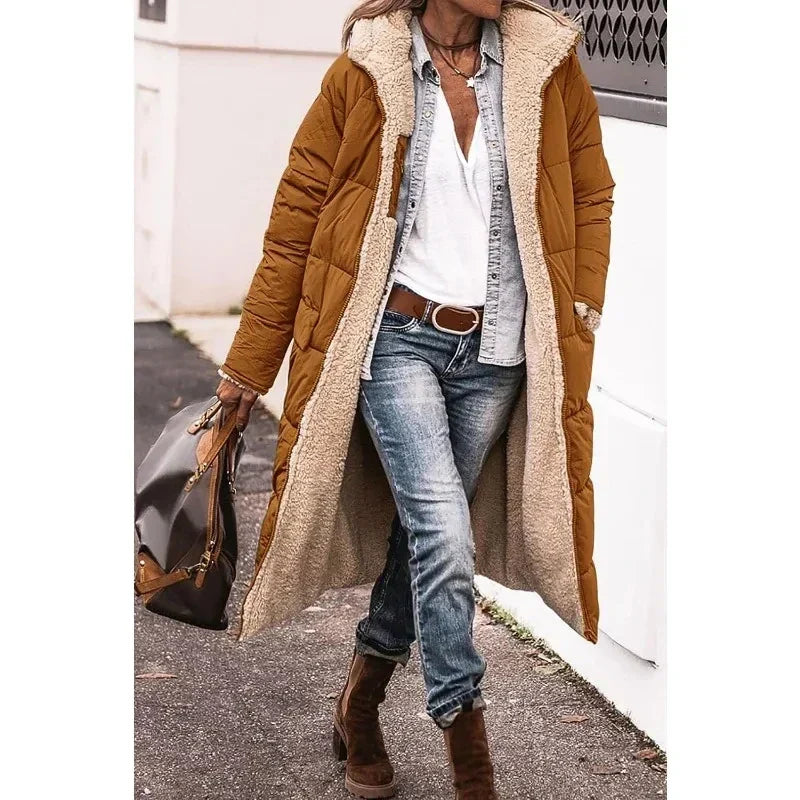 Elegante dames lange pufferjas met capuchon. Deze trendy winterjas biedt optimale warmte en stijl.
