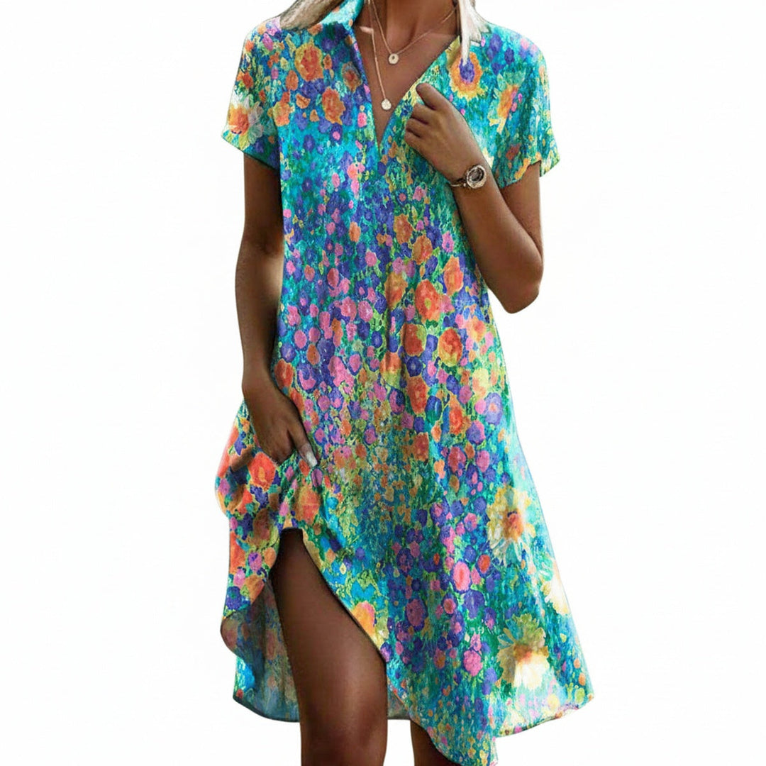 Modieuze dames midi jurk met vrolijke bloemenprint, korte mouwen en elegante asymmetrische zoom. Perfect voor zomer.