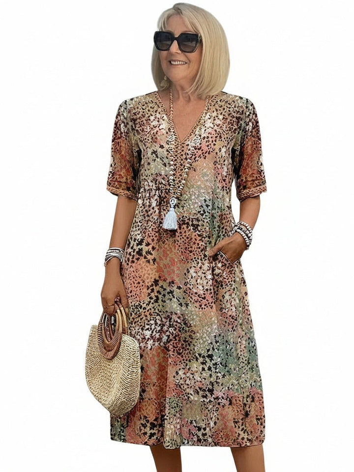 Elegante dames midi jurk met bloemenprint, V-hals en korte mouwen. Perfecte zomerjurk voor casual of chique.