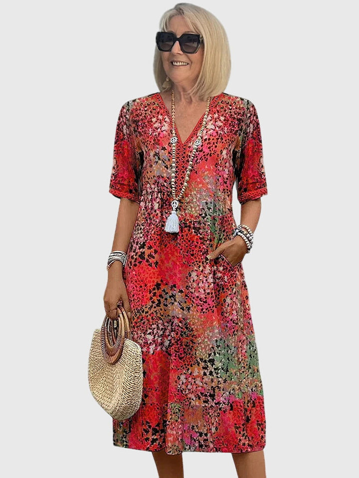 Stijlvolle dames midi jurk met fleurige bloemenprint, V-hals en korte mouwen. Een comfortabele A-lijn zomerjurk.