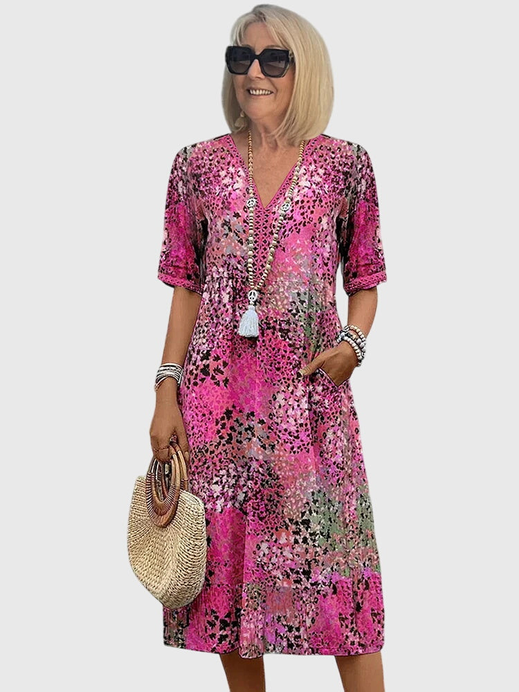 Comfortabele A-lijn midi jurk voor dames, met V-hals, korte mouwen en vrolijke bloemenprint. Geschikt voor elke dag.