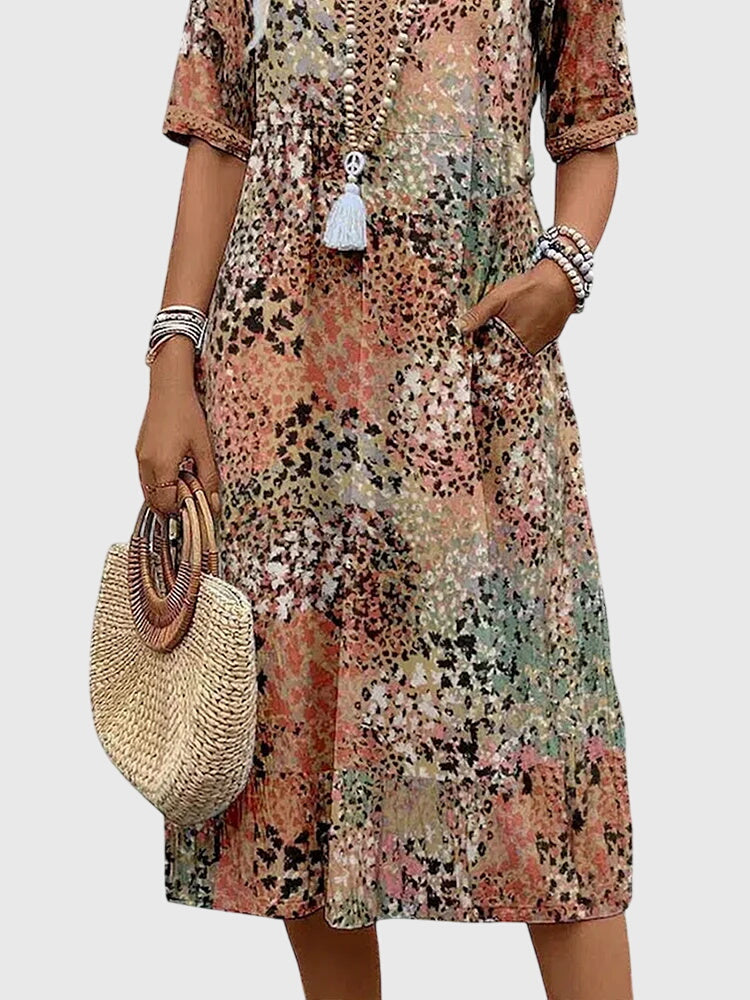 Chique dames midi jurk, A-lijn model, met elegante V-hals, korte mouwen en bloemenprint. Ideaal voor de zomer.