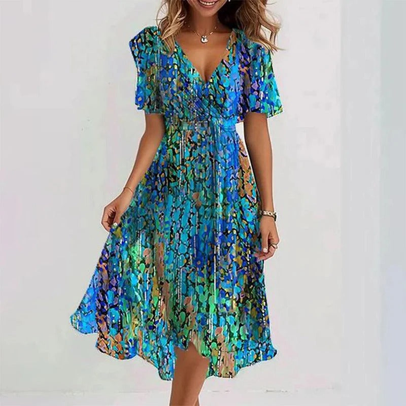 Betoverende dames midi jurk met bloemenprint, V-hals, vlindermouwen en een comfortabele A-lijn silhouet.