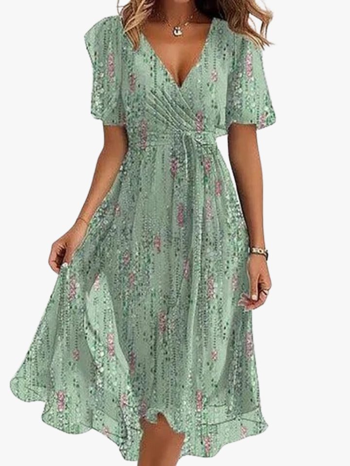 Elegante dames midi jurk met V-hals, vlindermouwen en levendige bloemenprint, ideaal voor zomerse dagen.