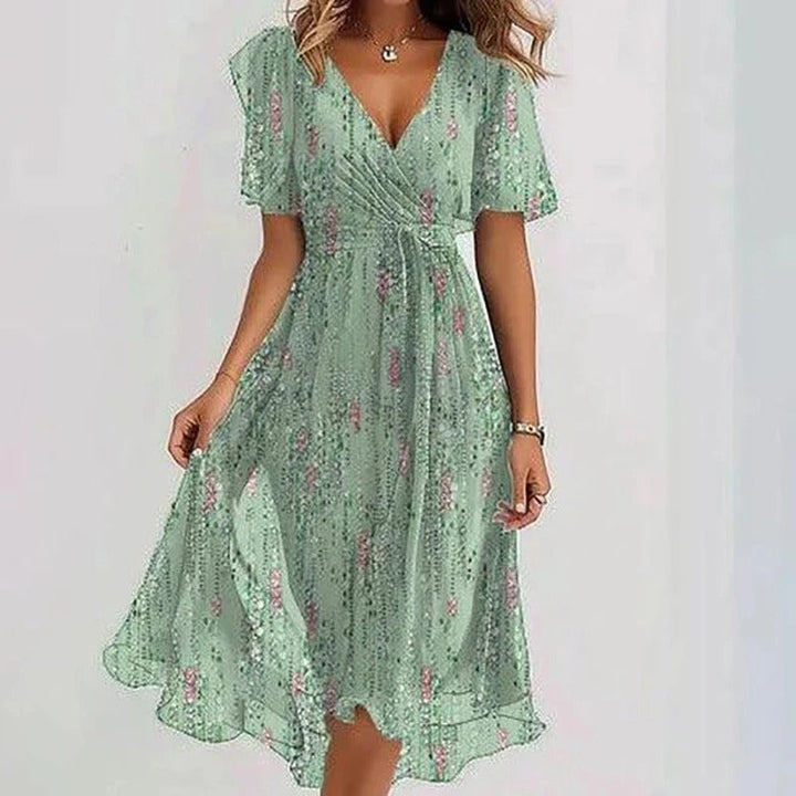 Casual A-lijn midi jurk voor dames met bloemenprint, V-hals en speelse vlindermouwen. Perfecte zomerjurk.