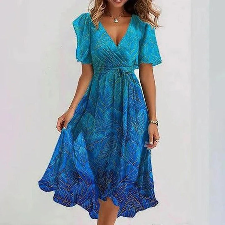 Zomerse dames midi jurk met frisse bloemenprint, comfortabele V-hals en luchtige vlindermouwen. A-lijn model.