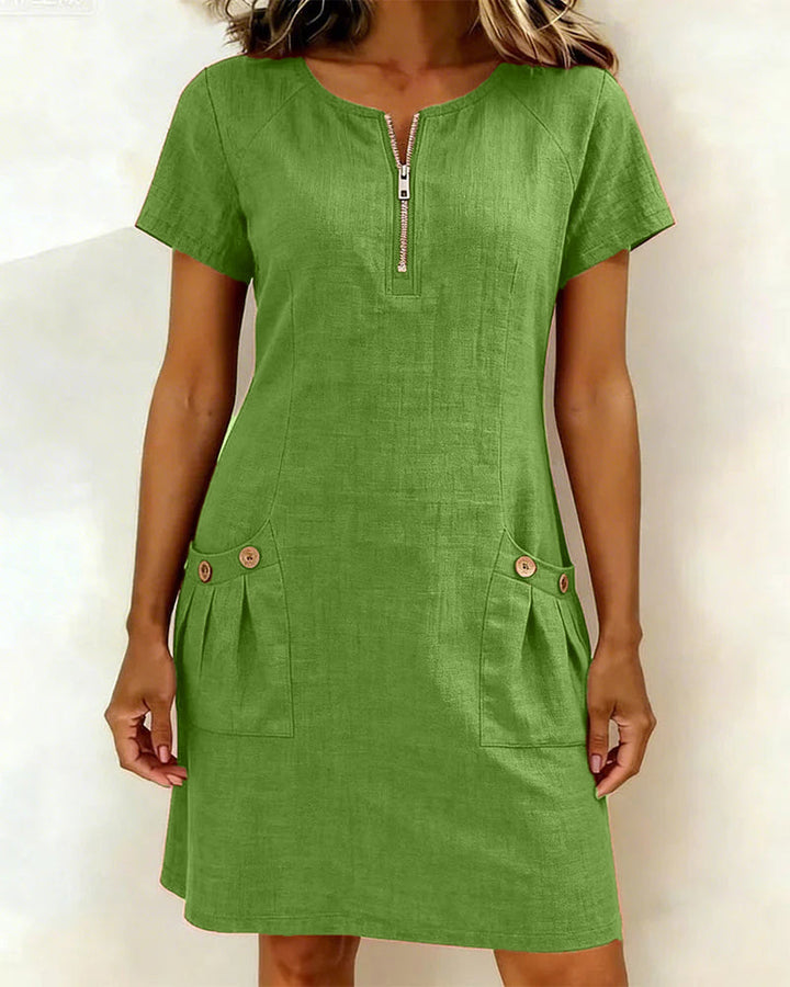 Lente/zomer dames mini jurk. Korte mouw, ronde hals, A-lijn, rits & zakken. Casual chic.