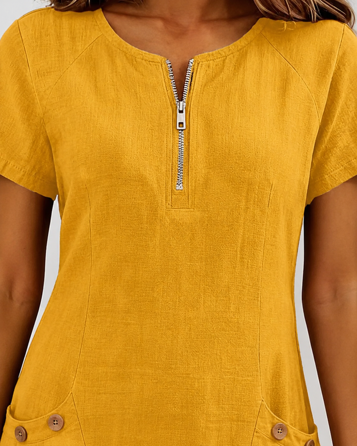 Comfortabele lentejurk dames. Mini lengte, korte mouw, ronde hals, rits en praktische zakken.