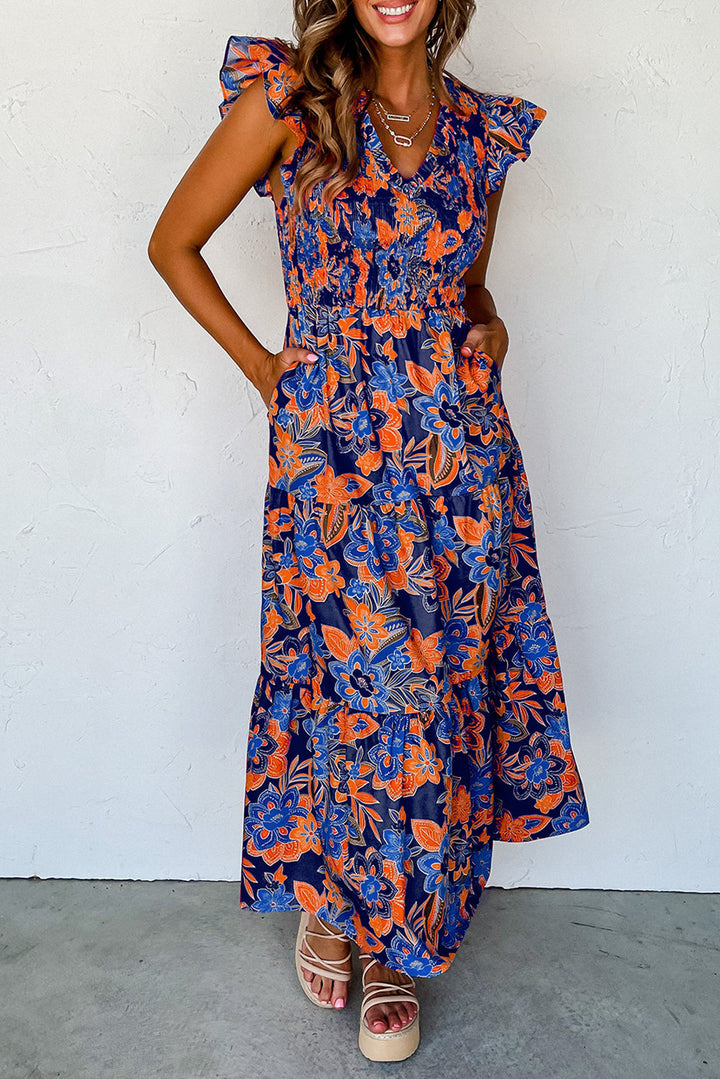 Elegante dames smocked maxi zomerjurk met bloemenprint, V-hals en zwierige rok. Perfect voor boho stijl.