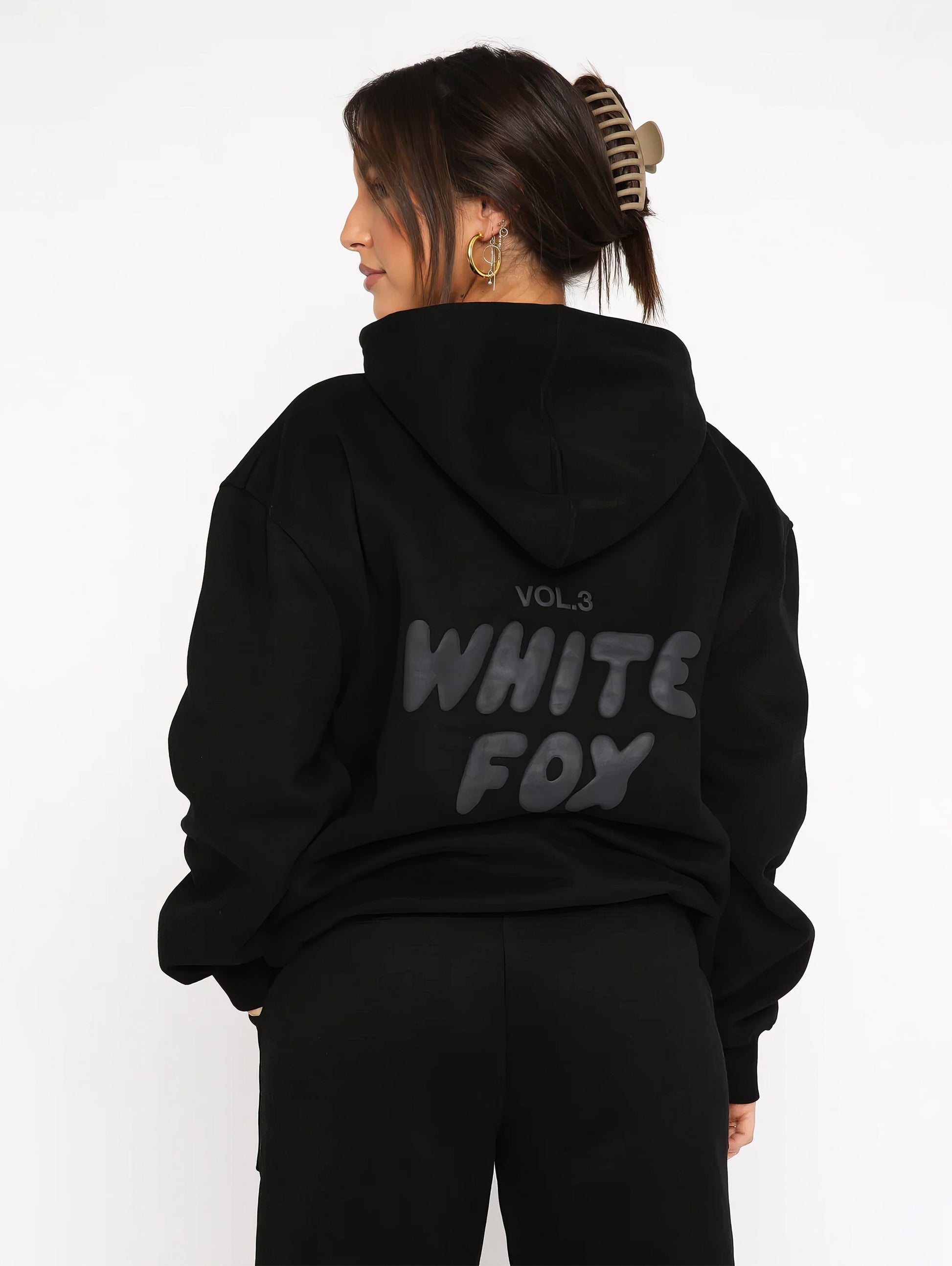 "Dames trainingspak met oversized pasvorm, wit, elastische ribboorden, trendy puffprint logo en fleecestof."