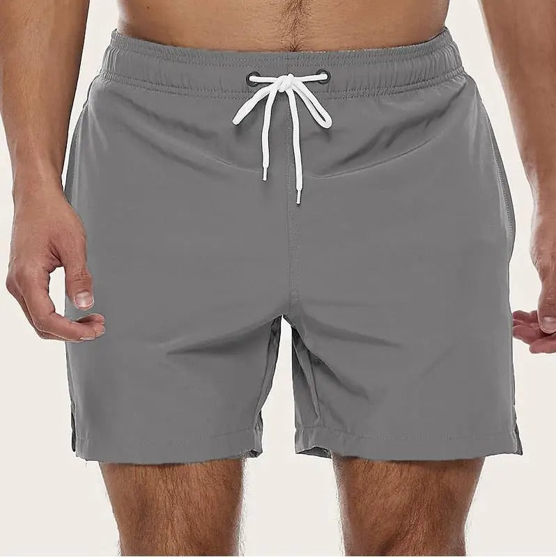 Detaillering van de elastische tailleband van een heren zwembroek, voor optimale pasvorm en comfort bij strandactiviteiten.