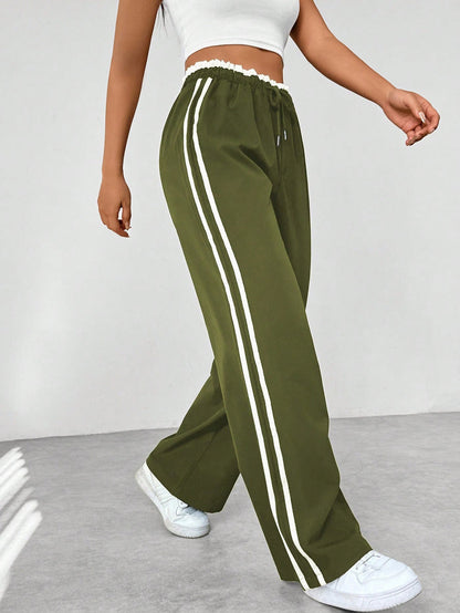 Donkerblauwe joggingbroek met witte strepen, elastische tailleband, sportief en trendy design, damesmode.
