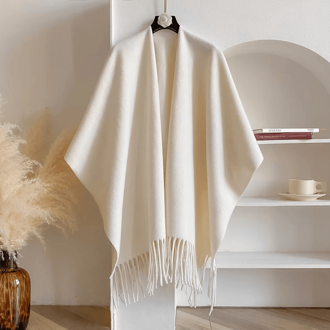 Dames dubbelzijdige poncho, ideaal als warme, stijlvolle bovenkleding voor elke gelegenheid. Comfortabel en veelzijdig.