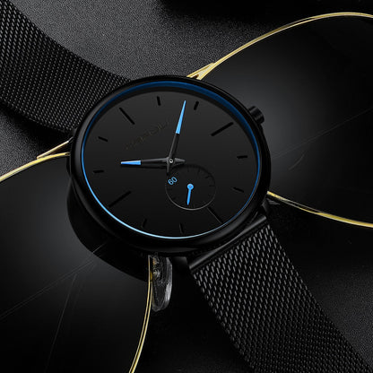 "Dun minimalistisch herenhorloge met elegante zwarte wijzerplaat, roestvrijstalen mesh-band en luxe uitstraling."