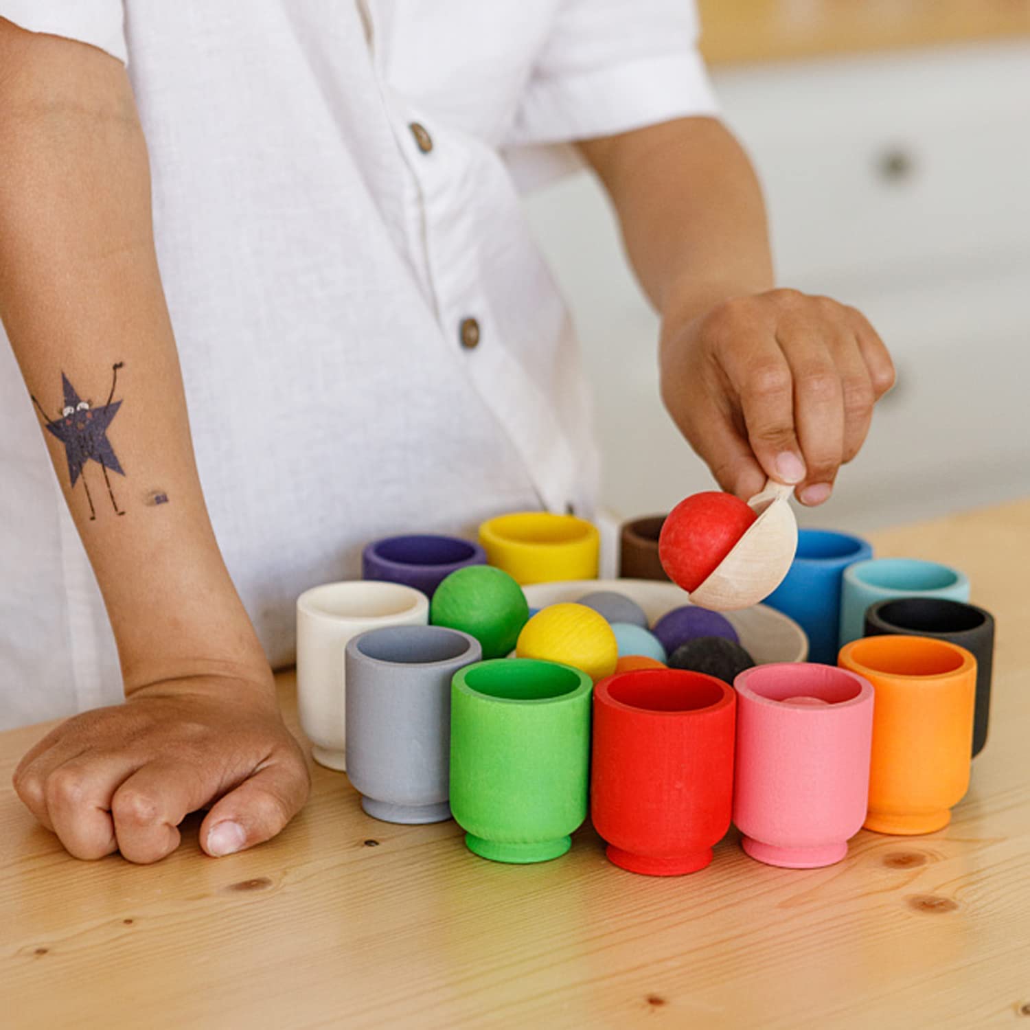 Educatief houten kleuren sorteerspel voor kinderen met kleurrijke ballen en lepel, stimuleert zintuiglijke ontwikkeling.