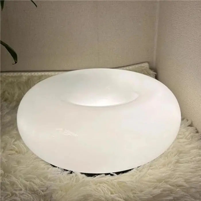 Minimalistische donut wandlamp van wit glas, LED verlichting voor een strakke uitstraling.