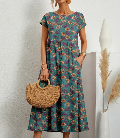 "Elegante A-lijn zomerjurk met kleurrijke bloemenprint, korte mouwen en lange rok, gemaakt van licht katoenen stof."