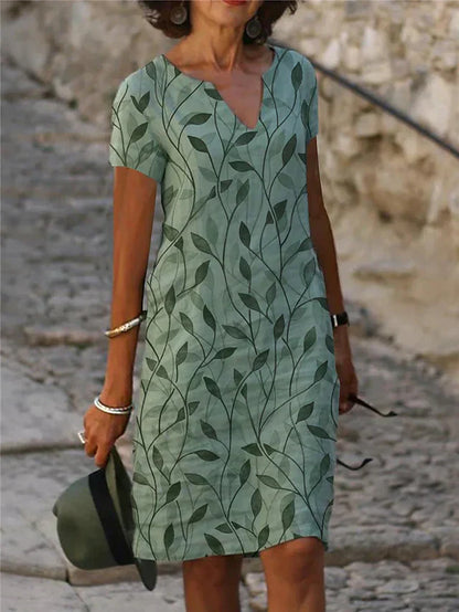 "Elegante groene en blauwe midi-jurk met V-hals en korte mouwen, ideaal voor zomerdagen. Vrouwelijke en stijlvolle look."