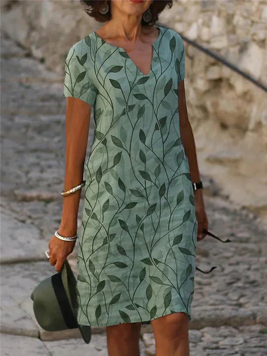"Elegante groene en blauwe midi-jurk met V-hals en korte mouwen, ideaal voor zomerdagen. Vrouwelijke en stijlvolle look."