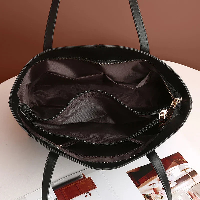 Elegante leren schoudertas in rood, met verstelbare riem en ruim interieur, perfect voor dagelijkse organisatie en stijl.