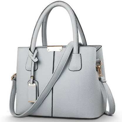 Elegante leren schoudertas voor dames, stijlvol en ruim, met verstelbare riem en verschillende kleurkeuzes.