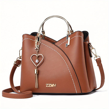 "Elegante luxe leren handtas met stijlvol kleurblokontwerp en kwastjes, perfect voor de moderne vrouw, frontaal gezien."