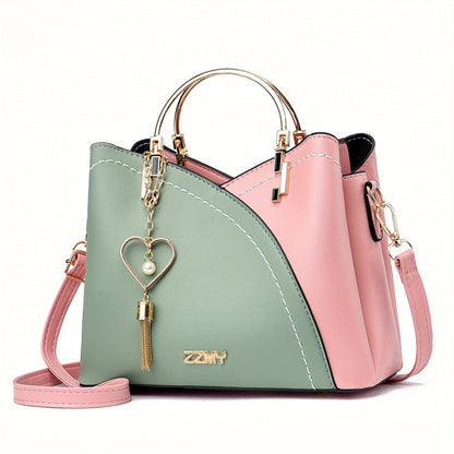 "Elegante luxe leren handtas met stijlvol kleurblokontwerp en kwastjes, perfect voor de moderne vrouw, frontaal gezien."