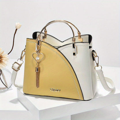 "Elegante luxe leren handtas met stijlvol kleurblokontwerp en kwastjes, perfect voor de moderne vrouw, frontaal gezien."