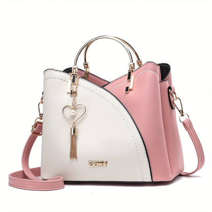 "Elegante luxe leren handtas met stijlvol kleurblokontwerp en kwastjes, perfect voor de moderne vrouw, frontaal gezien."